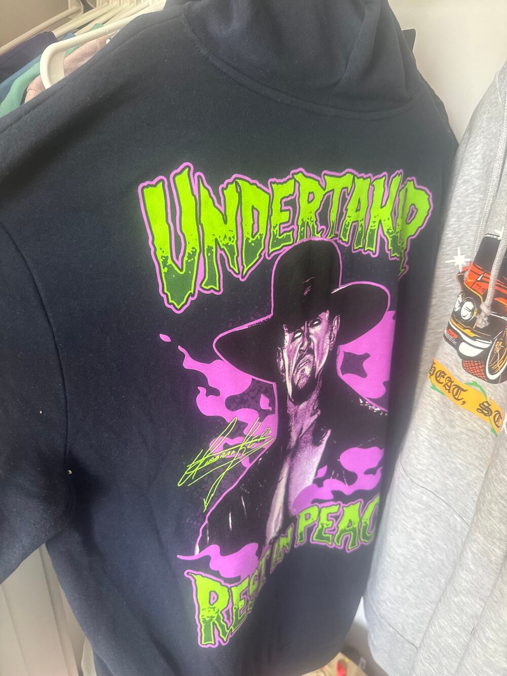 Undertaker graphic pullover hoodie in black with neon green and purple print